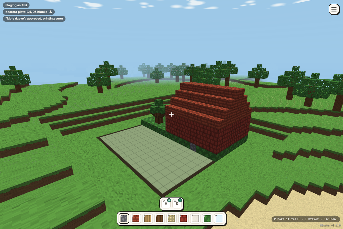 A child's house in Blocks: brick walls, a stepped roof and a little garden, built on one printable plate.